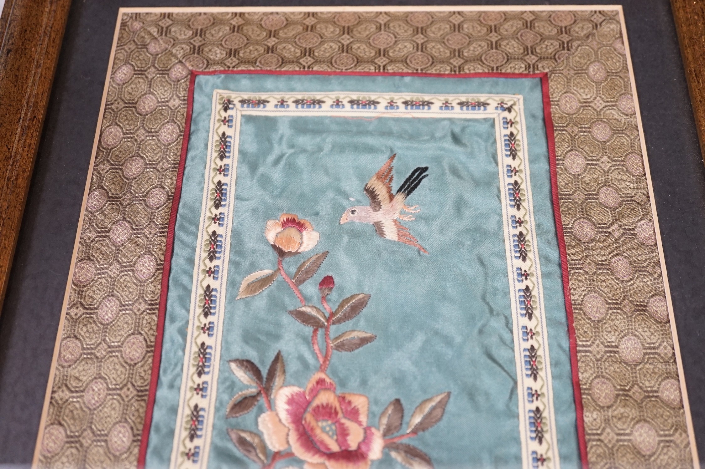 A pair of framed Chinese embroideries with bird and flower decoration, 34 x 14cm